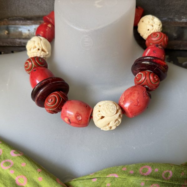 Stunning, antique 19” necklace created by Artist Barbara Wright of Dallas TX, is double knotted by hand on silk thread. It’s handmade of Chinese carved natural materials, coral, carved cinnabar and bovine materials creating a striking Asian statement piece!