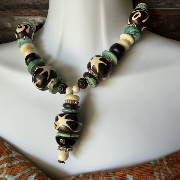 43. This artist Barbara Wright of Dallas, TX Turquoise and African Batik Beaded Necklace is a stunning piece of jewelry that showcases an African ethnic and regional style with a knot pendant shape. Hand-knotted on silk thread!