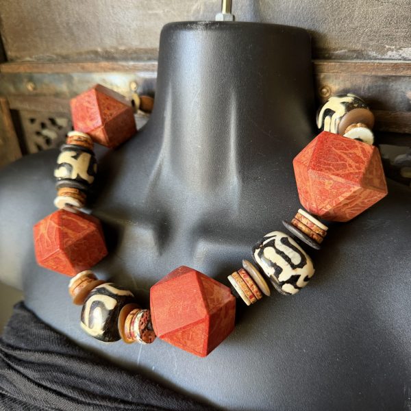 30. This necklace is an artisanal "statement" piece designed by artist Barbara Wright of Dallas, Texas. This necklace features a blend of African hand-batiked trade beads, and beautiful large Himalayan geometric coral beads.