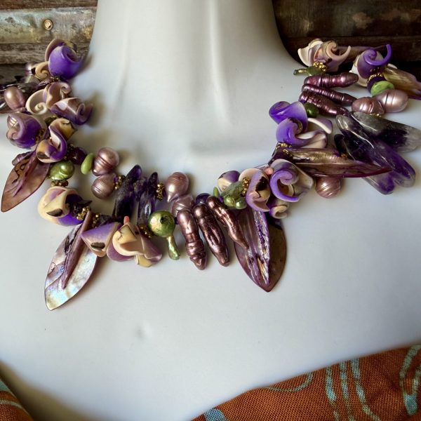 38. This necklace , designed by artist Barbara Wright of Dallas TX, is a double -stranded Amethyst , Gilded Natural Pearls, Jade, Mother of Pearl and purple Shells necklace. It is a handmade piece of jewelry that exudes elegance and sophistication.- fit for a mermaid Queen! Each bead is double-knotted by hand on silk thread.
