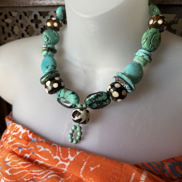 15. This artist Barbara Wright of Dallas, TX Turquoise and African Batik Beaded Necklace is a stunning piece of jewelry that showcases an African ethnic and regional style with a knot pendant shape. Hand-knotted on silk thread, this necklace features beautiful blue turquoise beads that reflect the vibrant colors of Kenya. The intricate craftsmanship and unique design make it a standout accessory for any outfit, embodying both traditional African elements and modern style.
