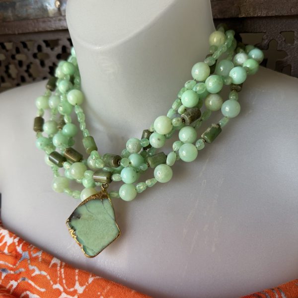 32. This breathtaking pendant necklace designed by artist Barbara Wright of Dallas, Texas, features three strands of beautiful green Chrysoprase crystal stones set in gold, (not sure of the purity) providing a stunning and elegant look.