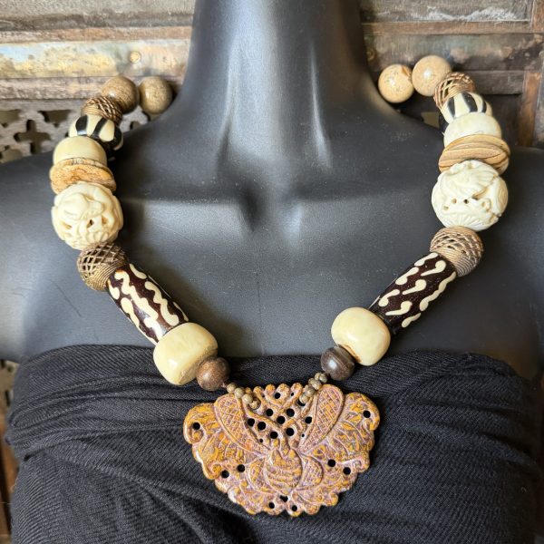 8. This pendant features a beautifully carved butterfly design on gorgeous piece of Jasper, accented with African batik beads, lacework metal beads, and carved Chinese Bovine beads featuring animals (birds and cows). This necklace was designed by artist Barbara Wright, of Dallas, TX! The ethnic and regional style reflects local artisans of both China AND Africa, making it a unique and culturally-inspired piece of jewelry.
