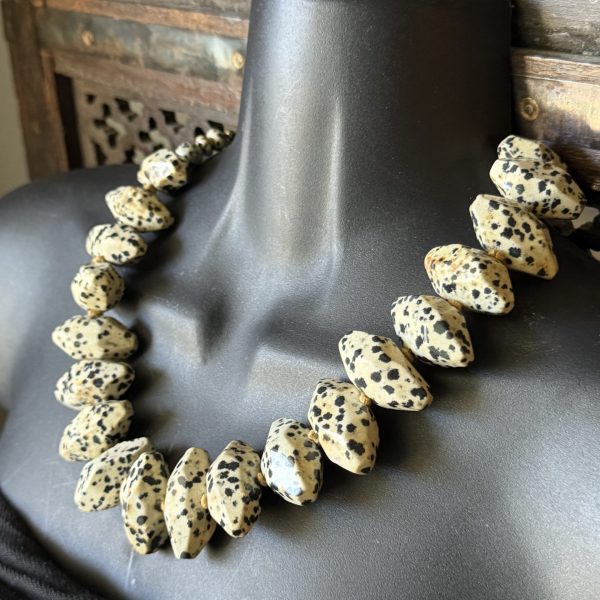 18. This is a Dalmatian Jasper Necklace by Dallas, TX designed by artist Barbara Wright, is a 19" hand-knotted piece on silk thread, featuring old diamond-shaped Dalmatian Jasper stone beads. This unique necklace showcases the beauty and craftsmanship of artisan jewelry, making it a standout accessory for any outfit. Made with high-quality materials, this necklace is a stylish and elegant choice for those looking to add a touch of luxury to their ensemble.
