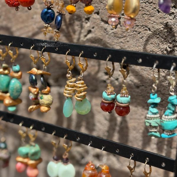 We have a variety of beautiful already designed earrings created from the use of her feet from local artist and Polio survivor , Jo Anne Brooks. She can make them to match any necklace! Message us now to get your custom made earrings , including clip-one, in nearly any material (semi-precious stones, ceramic beads, copper, silver , etc) and color palette NOW!